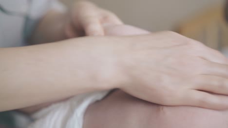 newborn baby lies on special table and enjoys massage