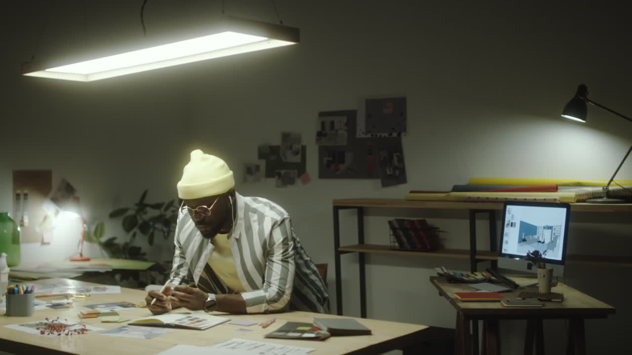A man working diligently at his desk in a modern office