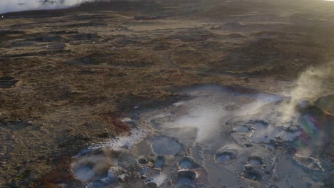 steam rising from geothermal mud pools in reykjanes, iceland