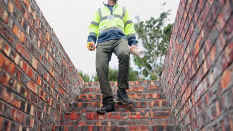 construction worker inspecting brickwork