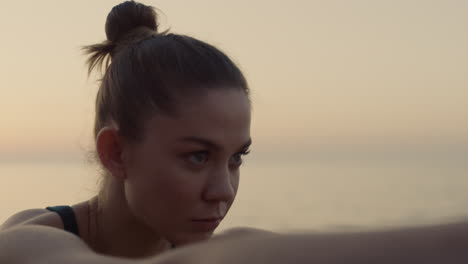 woman performing warrior three pose on beach close up. girl training on seacoast