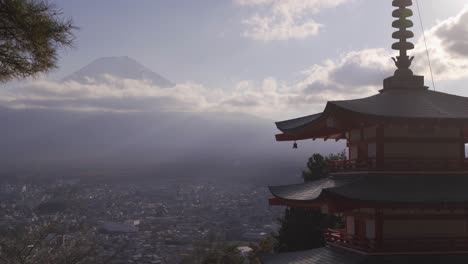 medium shot of chureito pagoda with beautiful mount fuji and clouds