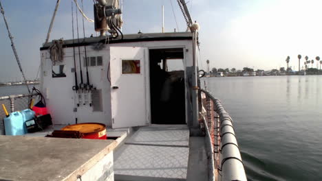 A-boat-passes-through-a-marina-where-many-boats-are-docked