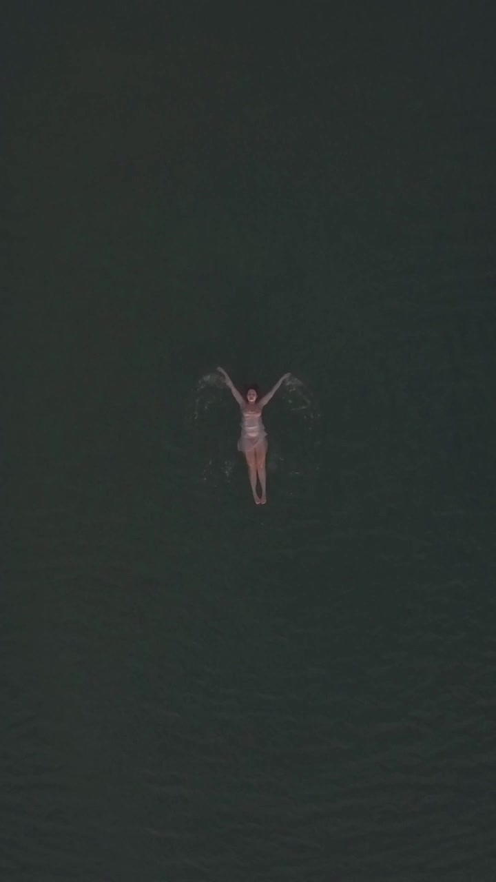 Aerial view of woman swimming in the sea