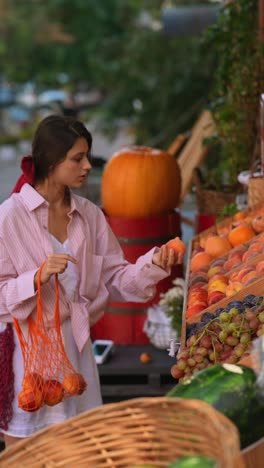 woman shopping for peaches at a farmer's market