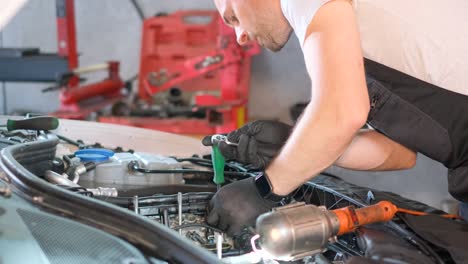mecánico que trabaja en un motor de automóvil