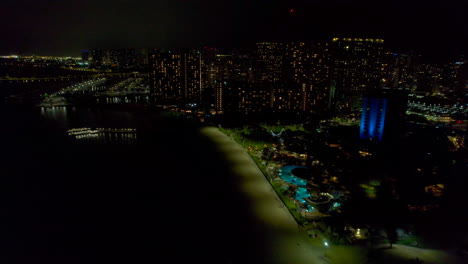 Nighttime-view-of-Fort-DeRussy-Beach-and-Kale-Hoa-hotel-with-other-buildings-in-Honolulu-Hawaii