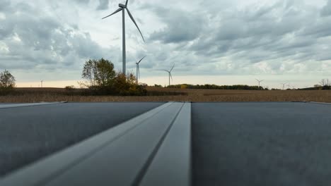 camera sitting on a truck bed with large wind turbines in the distance