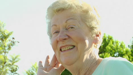 an elderly woman fluffs her hair