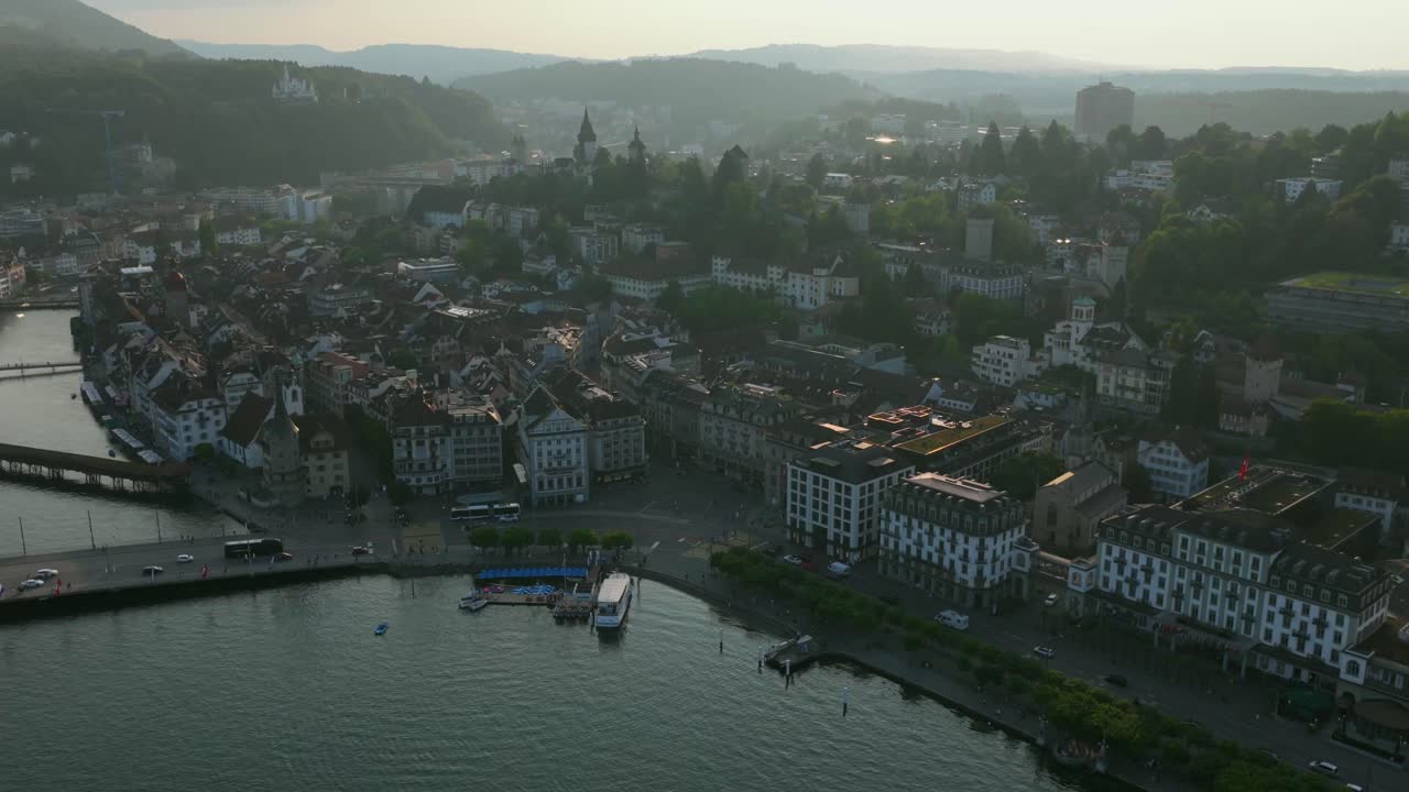 Wide shot of lakefront road and bridge connecting both sides of Lucerne’s old town