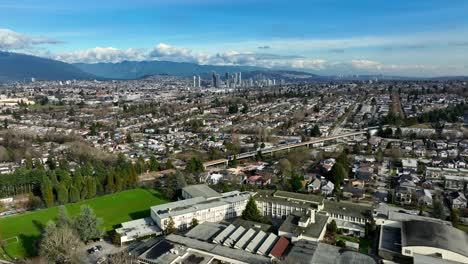 gladstone secondary school with trains on railroad in vancouver, bc, canada