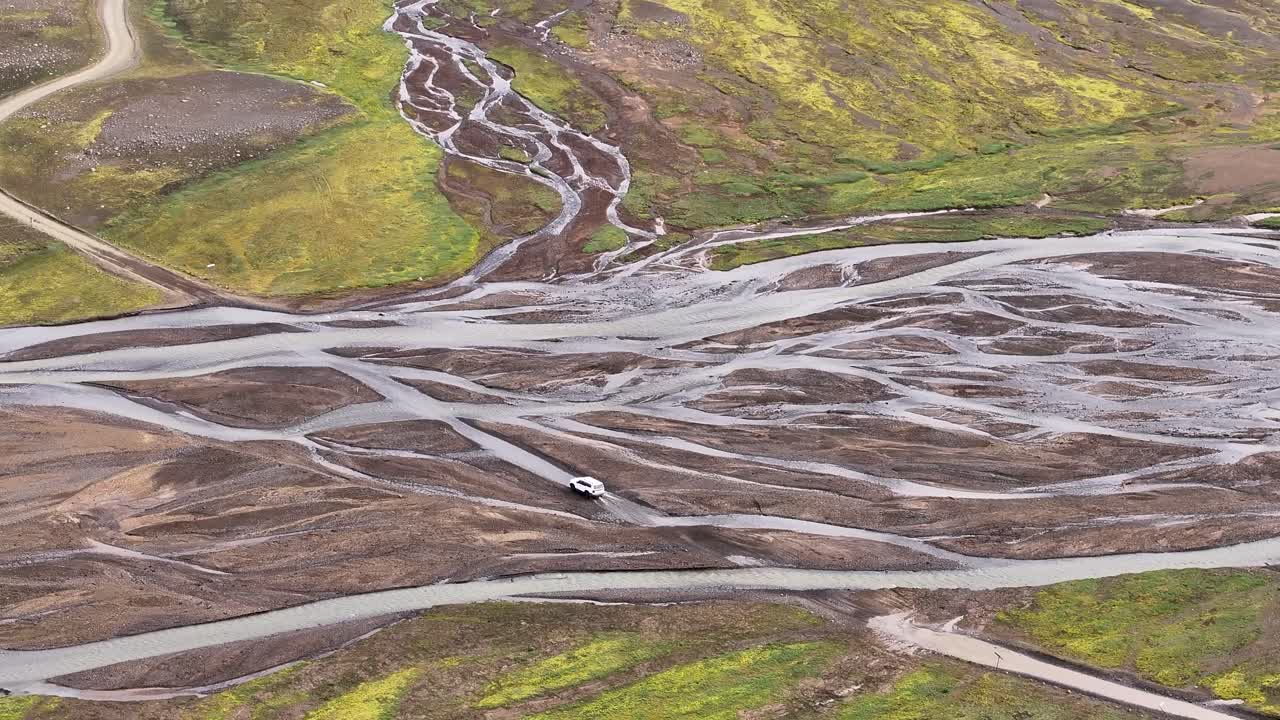 Aerial View Of 4x4 Car Driving Through Braided River In Nyjidalur, Iceland