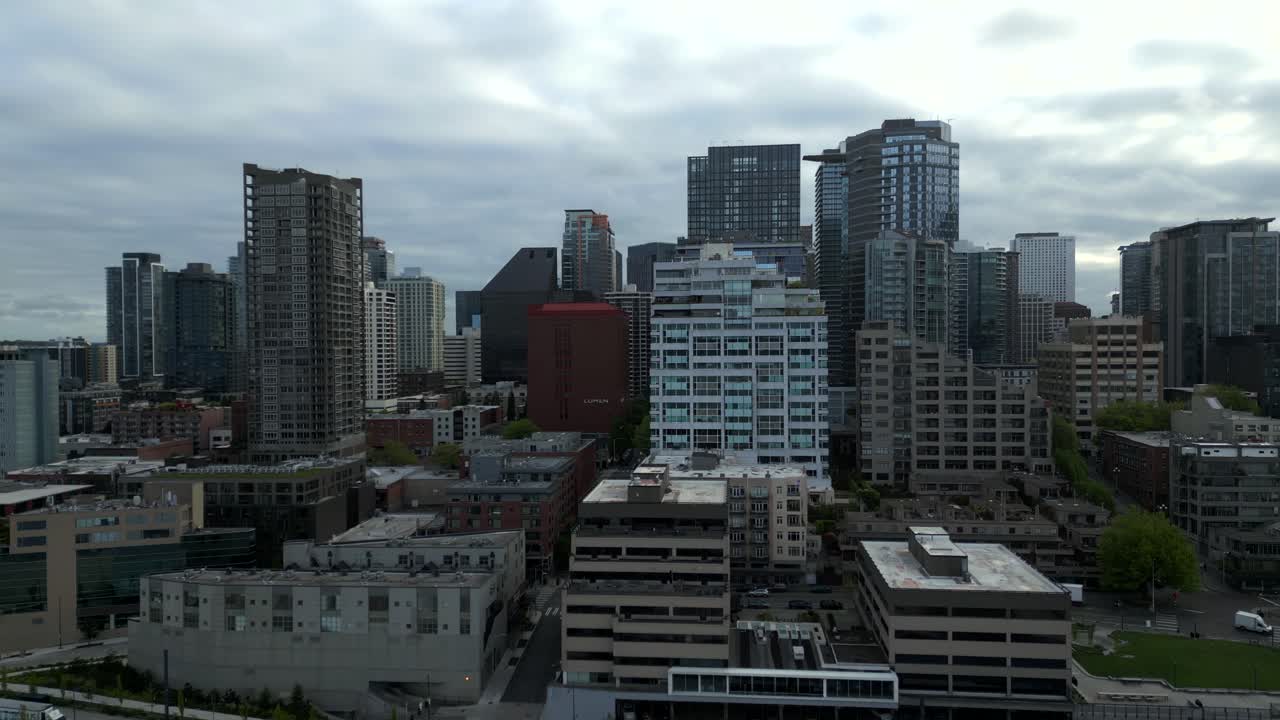 Aerial view of dense cityscape and mid-rise buildings along downtown Seattle, Washington, USA, during an overcast day.