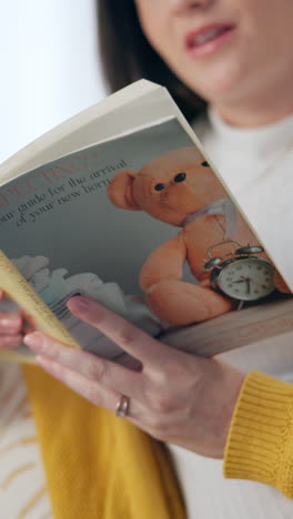 a woman reads a book titled 'expecting: a guide for the arrival of your newborn'