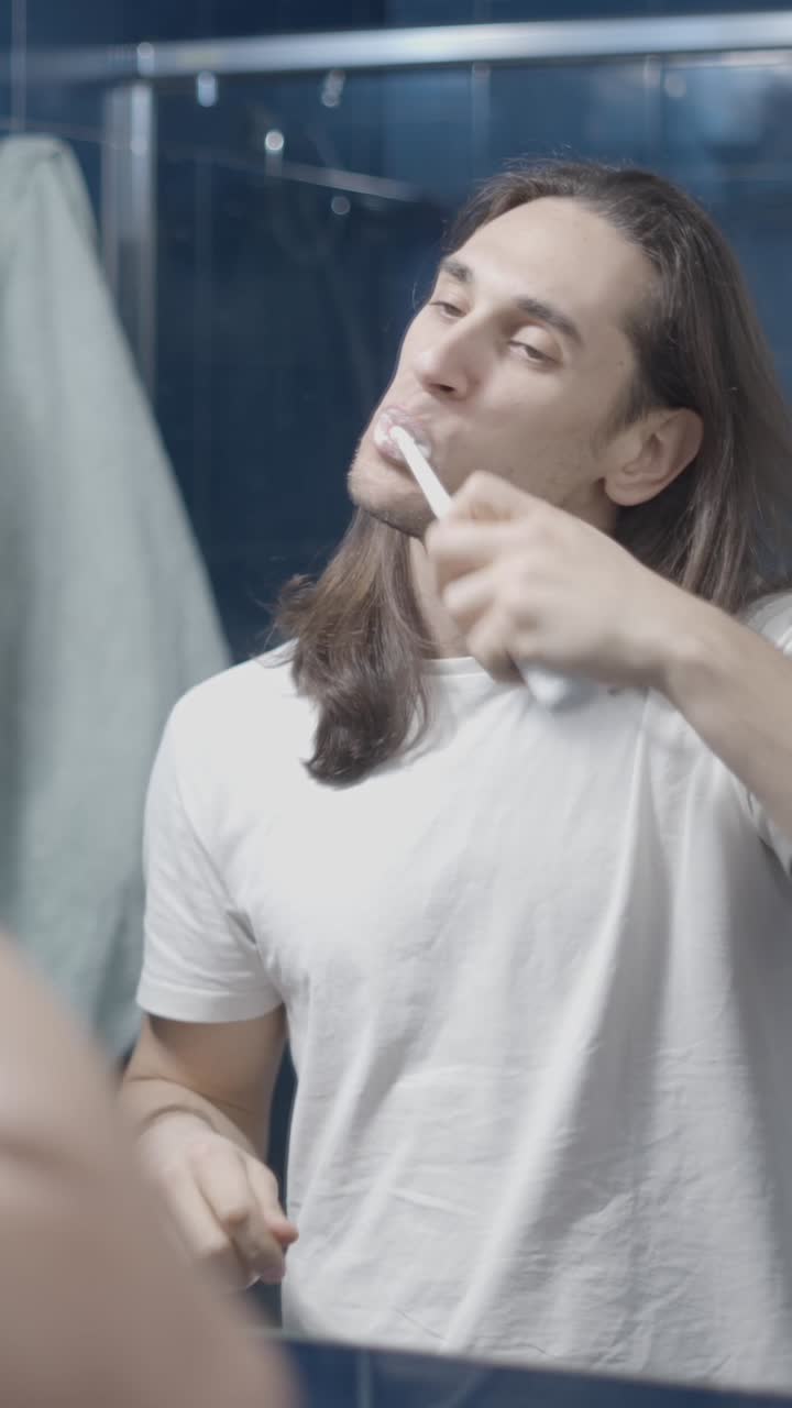 Man brushing his teeth in the bathroom