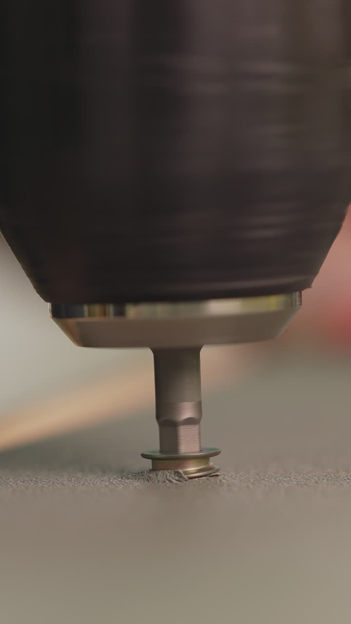 Worker installs screw with drill assembling furniture at home closeup. Builder with electric screwdriver screws fixture in wooden surface. Handyman at work
