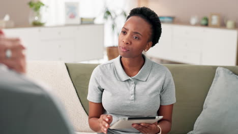 woman using tablet on couch