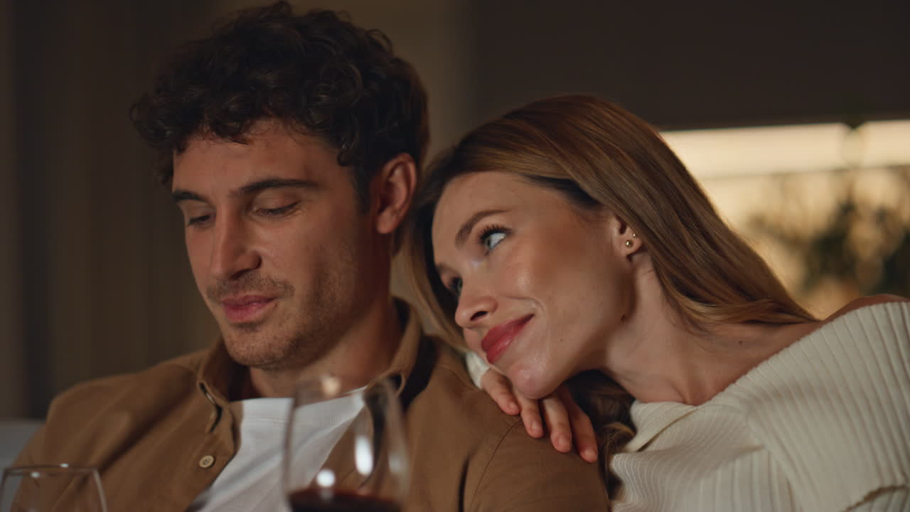 Family couple spending date at home holding wine glasses close up. Happy pair