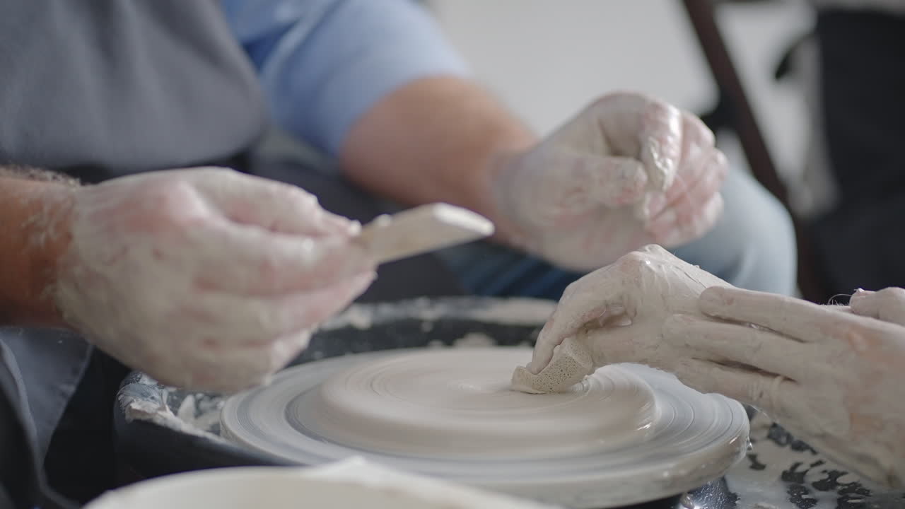Close-up of a male master working on a potter's wheel close-up in slow motion
