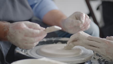 close-up of a male master working on a potter's wheel close-up in slow motion