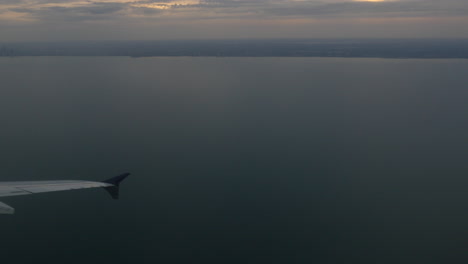 aerial view of a lake and distant city skyline from an airplane