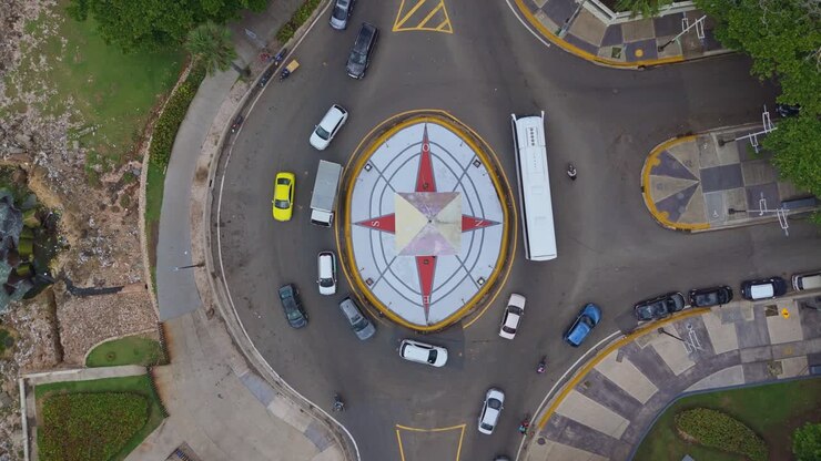 Top-down drone aerial view of Obelisk roundabout and traffic on George Washington Avenue, Santo Domingo.