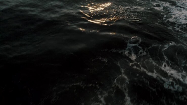 Low Flyover Glistening Ocean During Sunrise At Monterrico On The Pacific Coast Of Guatemala