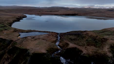 scenic view of systrafoss waterfall and systravatn lake in south iceland - drone shot