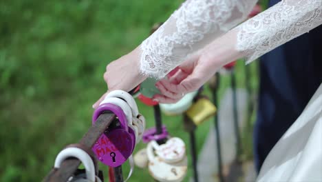 bride and groom attaching love locks