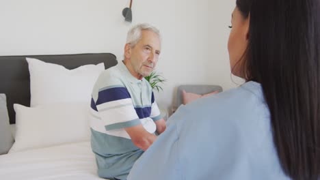 animation of biracial female doctor and caucasian senior man talking