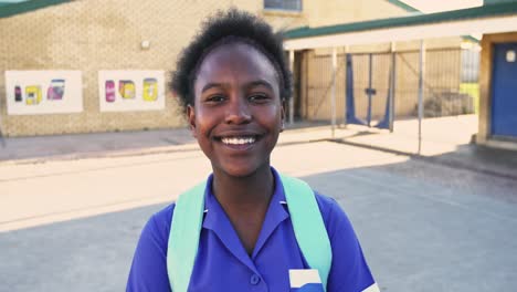 portrait of a young schoolgirl smiling in playground 4k