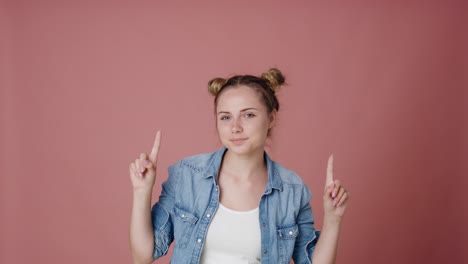 caucasian teenage girl pointing on copy space.