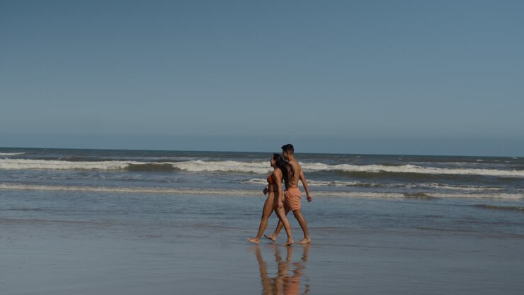 Cute couple walking on the beach