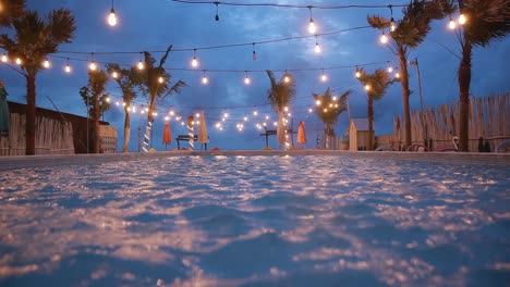 strong wind in the pool with a chandelier over the pool at night