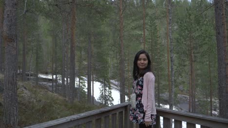 Girl-in-the-forest,-near-a-waterfall.-Slowmotion