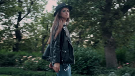 young girl model looking at camera and walking in the garden