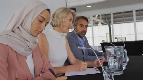 a panel of business delegates talking at a conference