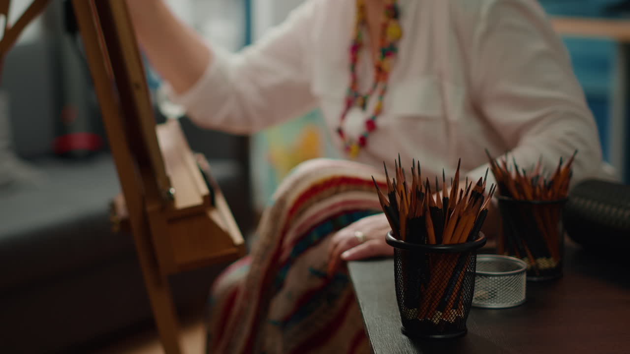 Colorful drawing pencils and artistic equipment on table
