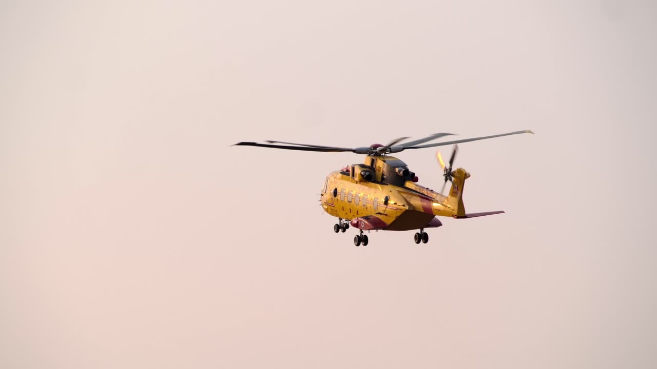 AgustaWestland CH-149 Cormorant SAR Helicopter Hovering Pink Sky REAR