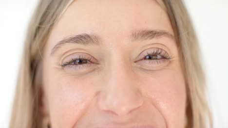 caucasian woman with light eyes is smiling