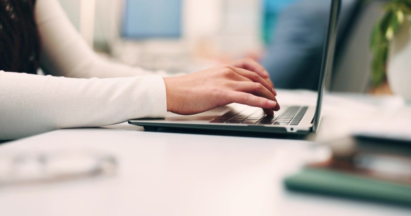 Close-up of Person Typing on Laptop in Office