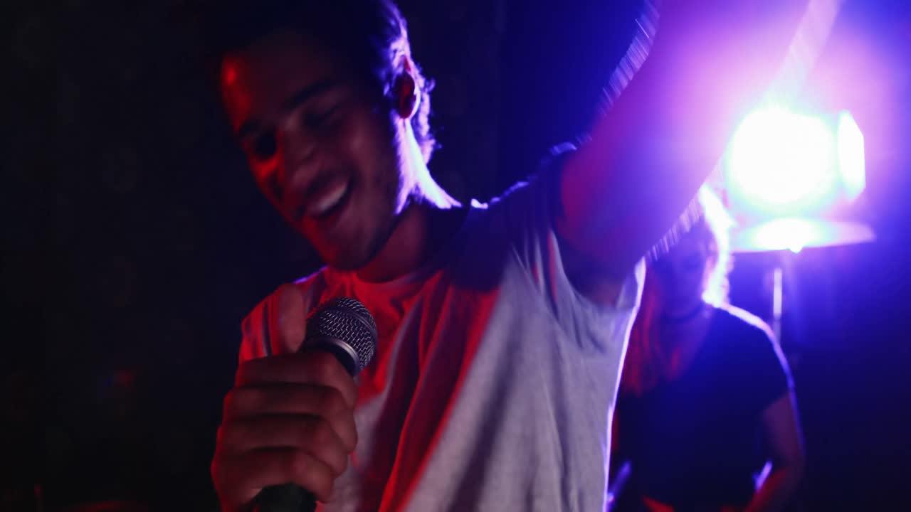 Male singer singing into a microphone 4k