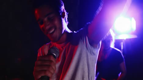 Male-singer-singing-into-a-microphone-4k