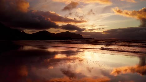 incredible golden reflections of the beautiful sunset on the surfer beach of flakstad lofoten islands, norway