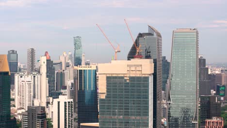 king power mahanakhon spotted behind some other tall buildings in bangkok, thailand