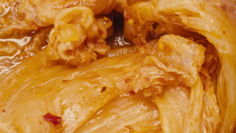Close-up of texture fermented spicy cabbage kimchi with in can. Preservation of vegetables in glass jars. Fermentation preserved kimchi cabbage with spices macro. Asian cuisine.
