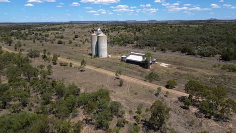 aerial view of a rural farm with silos in the australian outback