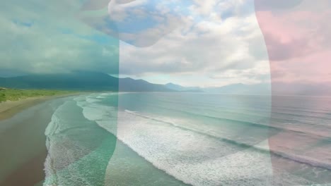 digital composition of italy flag waving against aerial view of waves in the sea