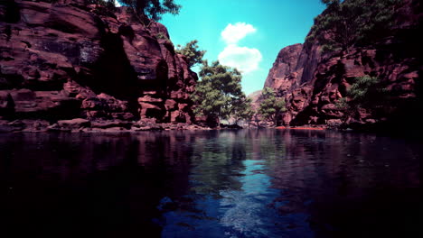 Reflection-in-Colorado-River-of-Butte-catching-days-last-rays,-in-Grand-Canyon.