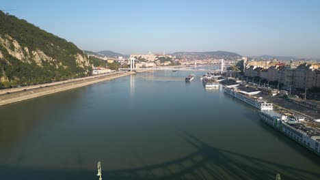 backwards drone shot reveals liberty bridge in budapest